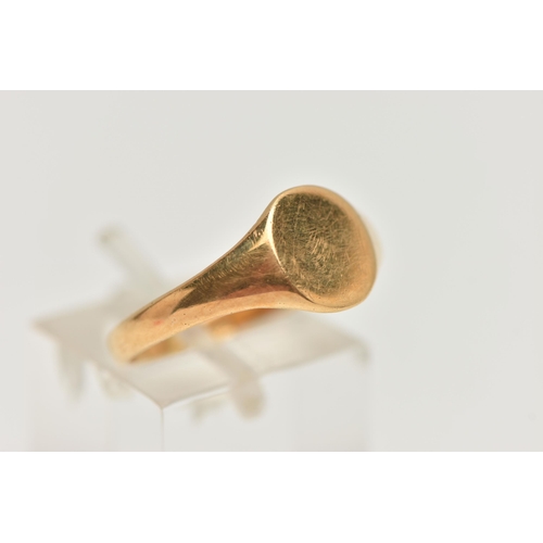 124 - A YELLOW METAL SIGNET RING, plain round signet with tapered shoulders, stamped 18ct, ring size Q 1/2... 