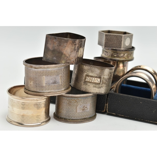 135 - AN ASSORTMENT OF SILVER NAPKIN RINGS, to include a cased set of four napkin rings with bead detail, ... 
