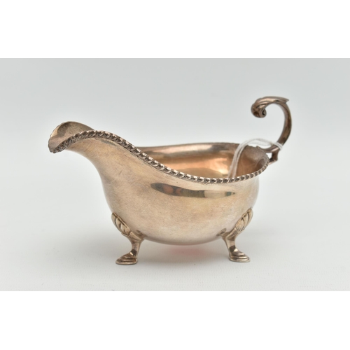 137 - A MID 20TH CENTURY SILVER GRAVY BOAT, polished form, gadrooned rim, fitted with a scroll handle, rai... 