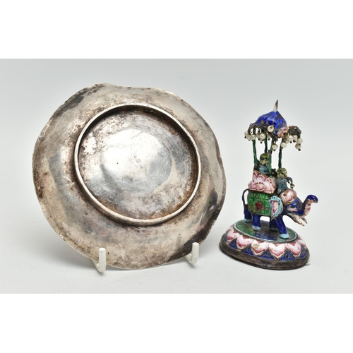 139 - A WHITE METAL DISH AND AN ENAMEL FIGURINE, circular dish decorated with two oriental dragons, unmark... 