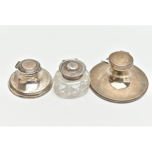 155 - THREE LATE 19TH TO EARLY 20TH CENUTRY SILVER INKWELLS, two of circular tapered design with hinged li... 