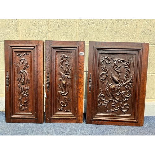 1321 - TWO PAIRS OF 20TH CENTURY MAHOGANY PANELED DOORS, and a single door, all with carved foliate detail,... 