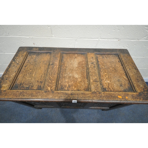 1203 - A GEORGIAN OAK COFFER, the hinged lid enclosing a candle box, three carved front panels, width 118cm... 