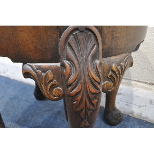 1213 - A REPRODUCTION OVAL WALNUT IRISH STOOL, with foliate drop in seat pad, on cabriole legs carved with ... 