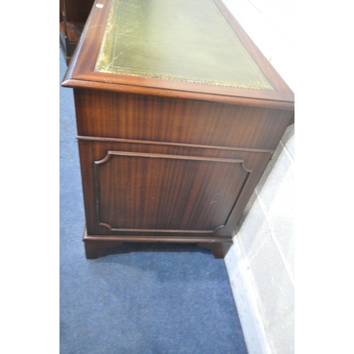 1216 - A 20TH CENTURY MAHOGANY PEDESTAL DESK, with a green tooled leather writing surface, fitted with an a... 