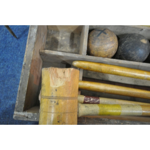 1232 - A VINTAGE CROQUET SET, in a wooden crate, comprising eight mallets, eight wooden balls, two pairs of... 