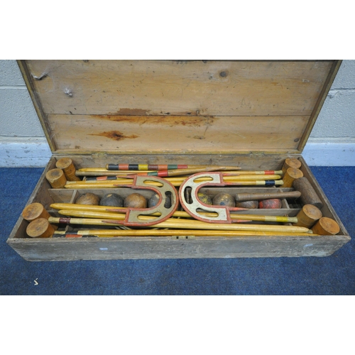 1232 - A VINTAGE CROQUET SET, in a wooden crate, comprising eight mallets, eight wooden balls, two pairs of... 