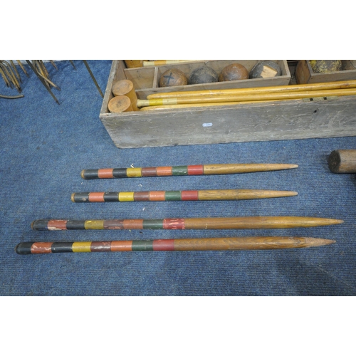 1232 - A VINTAGE CROQUET SET, in a wooden crate, comprising eight mallets, eight wooden balls, two pairs of... 