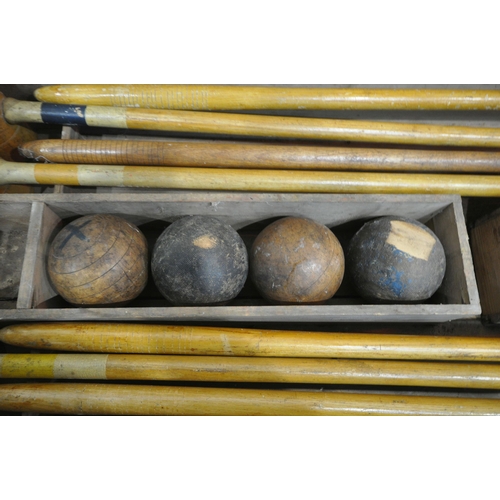 1232 - A VINTAGE CROQUET SET, in a wooden crate, comprising eight mallets, eight wooden balls, two pairs of... 