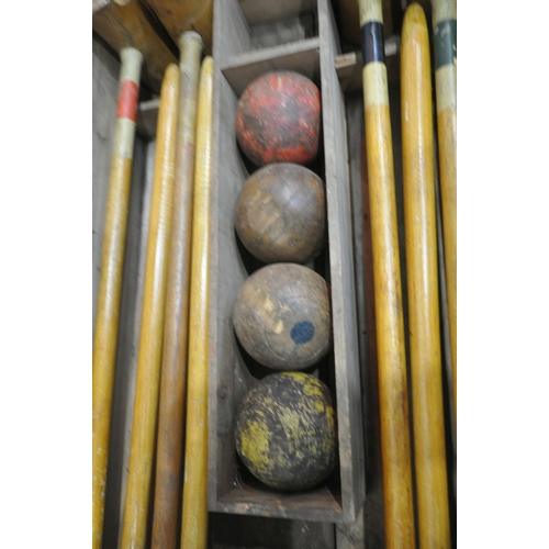 1232 - A VINTAGE CROQUET SET, in a wooden crate, comprising eight mallets, eight wooden balls, two pairs of... 