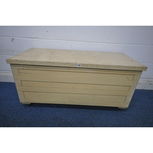 1261 - A CREAM PAINTED WOODEN TOOL CHEST, with a hinged lid, on castors, width 113cm x depth 49cm x height ... 