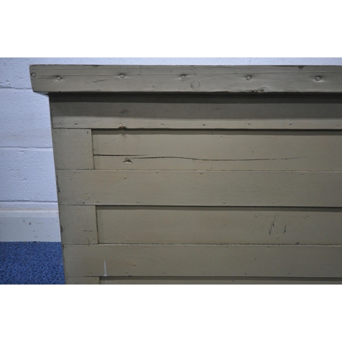 1261 - A CREAM PAINTED WOODEN TOOL CHEST, with a hinged lid, on castors, width 113cm x depth 49cm x height ... 