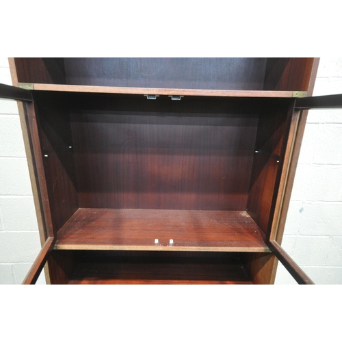 1341 - A MODERN MAHOGANY CAMPAIGN BOOKCASE, with two glazed doors and eight drawers, width 101cm x depth 36... 