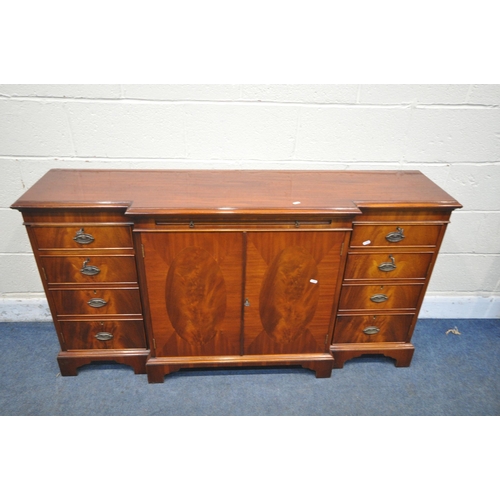 1345 - A MODERN MAHOGANY BREAKFRONT SIDEBOARD, fitted with two drawers, four cupboard doors and a brushing ... 