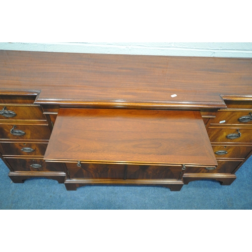 1345 - A MODERN MAHOGANY BREAKFRONT SIDEBOARD, fitted with two drawers, four cupboard doors and a brushing ... 