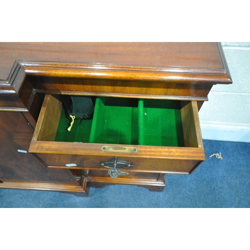 1345 - A MODERN MAHOGANY BREAKFRONT SIDEBOARD, fitted with two drawers, four cupboard doors and a brushing ... 