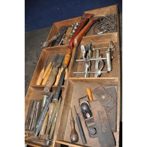 1109 - A LARGE VINTAGE CARPENTERS TOOLBOX CONTAINING CARPENTRY TOOLS with as steel banded lid  two inner li... 