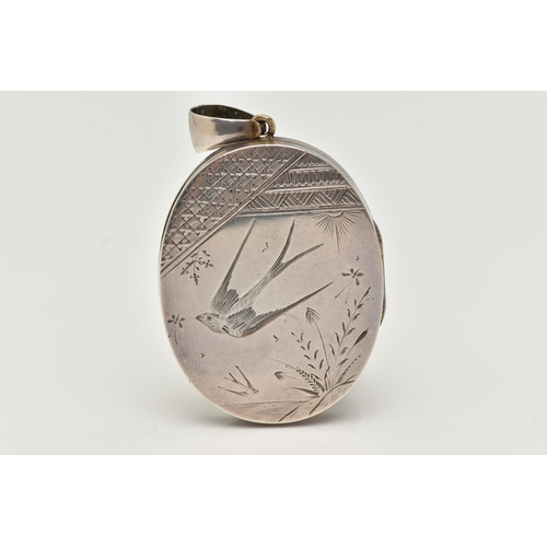 17 - A VICTORIAN WHITE METAL LOCKET, oval form locket, etched with a swallow and foliage design to the fr... 