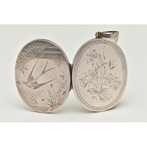 17 - A VICTORIAN WHITE METAL LOCKET, oval form locket, etched with a swallow and foliage design to the fr... 