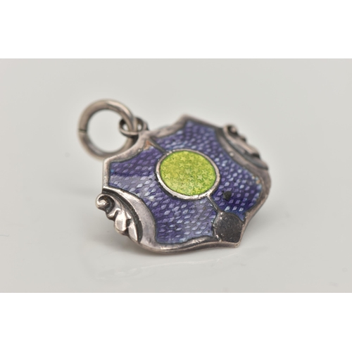 18 - A 'JAMES FENTON' PENDANT, a silver Arts and Crafts shield design pendant with blue and green enamel ... 