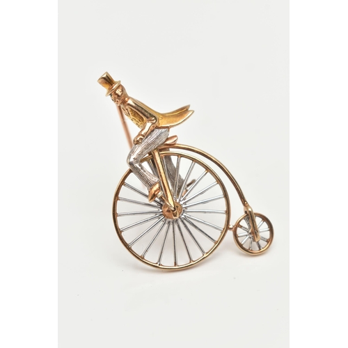 44 - A 9CT GOLD PENNY FARTHING BROOCH, a white and yellow gold gentleman riding a penny farthing bicycle,... 