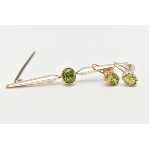 63 - A PERIDOT BAR BROOCH AND EARRINGS, an oval cut peridot collet set in yellow metal with milgran detai... 