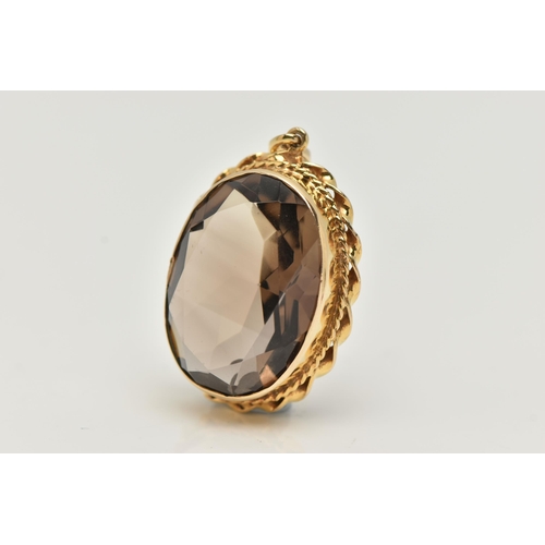 67 - A 9CT GOLD SMOKEY QUARTZ PENDANT, set with an oval shaped mixed cut smoky quartz, within a rope twis... 