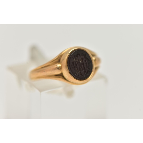 68 - AN EARLY 20TH CENTURY INTAGLIO RING, the oval hardstone, with initial monogram, to the grooved shoul... 