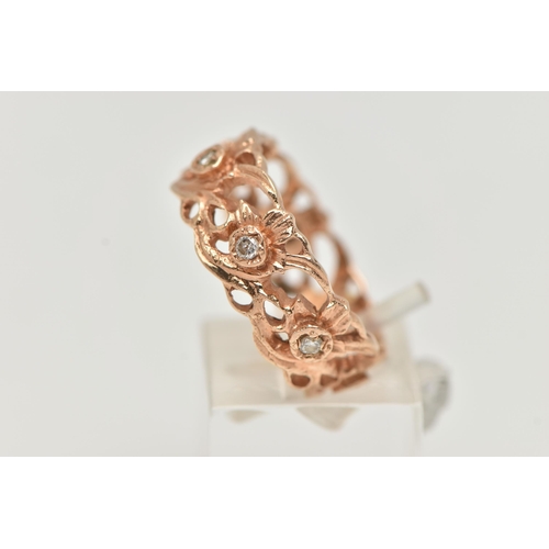 91 - A 14CT GOLD AND DIAMOND RING, a wide floral band with open work detail, set with seven prong set rou... 