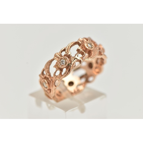 91 - A 14CT GOLD AND DIAMOND RING, a wide floral band with open work detail, set with seven prong set rou... 