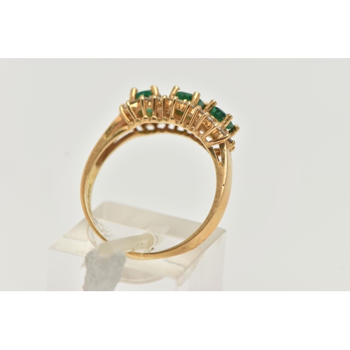 98 - AN 18CT GOLD EMERALD AND DIAMOND RING, designed as three claw set, oval cut emeralds, heavily includ... 