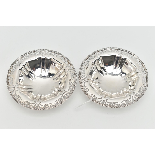 121 - A PAIR OF GEORGE V SILVER CIRCULAR BONBON DISHES, with gadrooned rims and foliate pierced borders, l... 