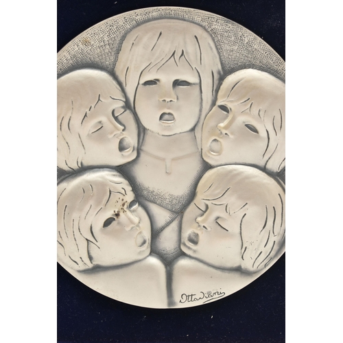 124 - A 'OTTA VIANI' FRAMED WHITE METAL PICTURE, a circular form disk depicting five children, signed 'Ott... 