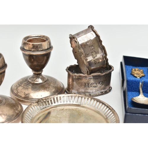 141 - A SELECTION OF SILVERWARE, to include a pair of dwarf candlesticks, a pair of napkin rings, a limite... 