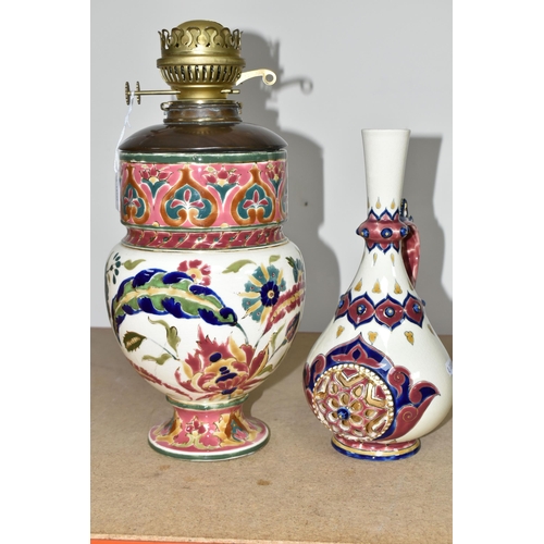 350 - A ZSOLNAY PORCELAIN OIL LAMP BASE AND RETICULATED ZSOLNAY VASE, the oil lamp is painted with an Orie... 