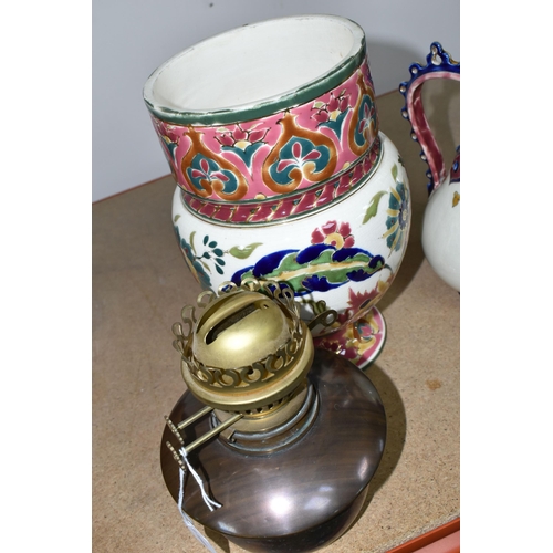 350 - A ZSOLNAY PORCELAIN OIL LAMP BASE AND RETICULATED ZSOLNAY VASE, the oil lamp is painted with an Orie... 