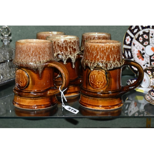 379 - FIVE ZSOLNAY STONEWARE TANKARDS, designed by Gyorgy Furtos, each decorated with an applied panel  em... 