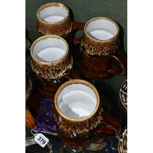 379 - FIVE ZSOLNAY STONEWARE TANKARDS, designed by Gyorgy Furtos, each decorated with an applied panel  em... 