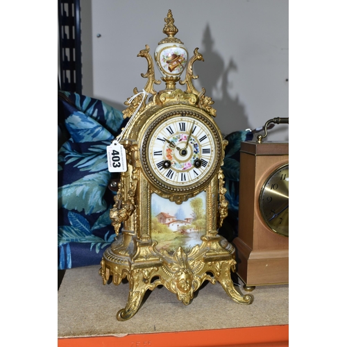 403 - A FRENCH STYLE GILT METAL MANTEL CLOCK, with hand painted porcelain dial and front panel, eight day ... 