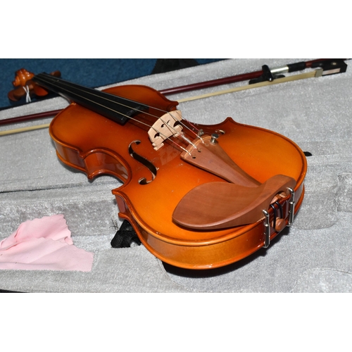 429 - A CASED HALF SIZE VIOLIN, having a two piece back, length 51cm, the bow having mother of pearl eyes ... 