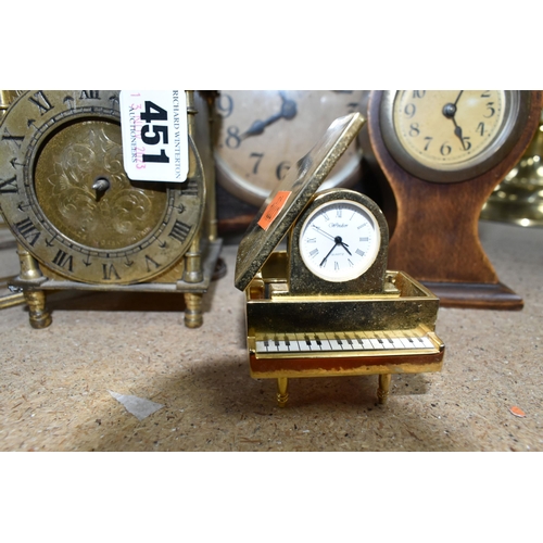 451 - A GROUP OF CLOCKS, comprising an electric gilt metal lantern clock, a small 'balloon' clock, an Art ... 