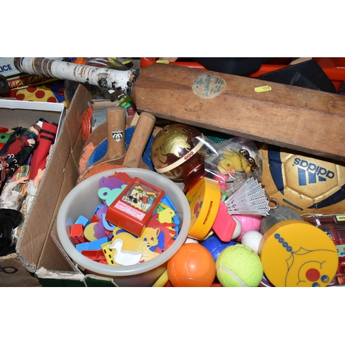 559 - FIVE BOXES AND LOOSE TOYS AND SPORTING EQUIPMENT, ETC, including a push along / sit on dog (a.f.), a... 