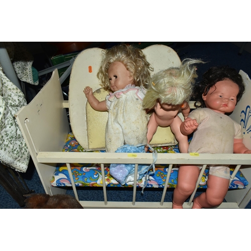 563 - A BOX AND LOOSE TOYS, DOLLS, PRAMS, COT, ETC, including a wicker doll's pram, assorted plastic dolls... 