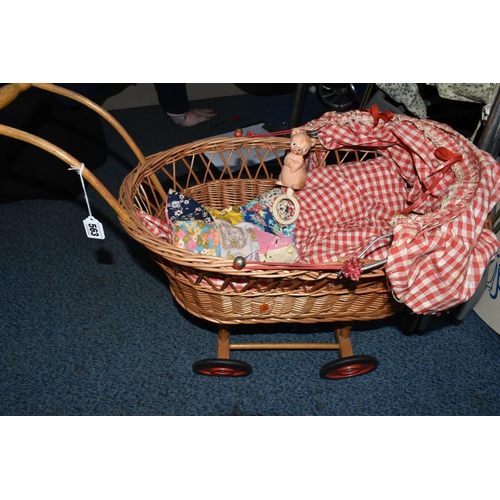 563 - A BOX AND LOOSE TOYS, DOLLS, PRAMS, COT, ETC, including a wicker doll's pram, assorted plastic dolls... 