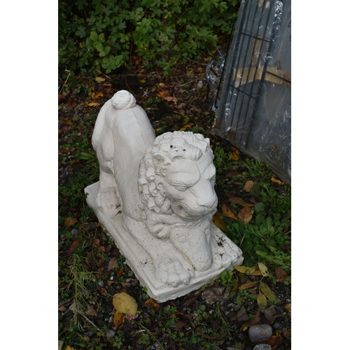 1012 - A PAINTED COMPOSITE GARDEN LION, with its prey, length 56cm x depth 27cm x height 34cm (condition re... 