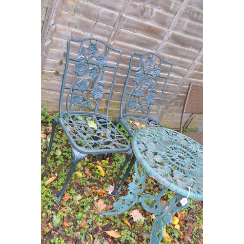 1021 - A GREEN PAINTED CAST ALUMINIUM GARDEN TABLE, and similar chairs, labelled Nova (3)