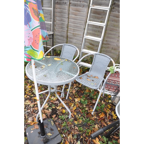 1023 - A CIRCULAR METAL AND GLASS GARDEN TABLE, diameter 60cn x height 70cm, a pair of rattan armchairs, pa... 