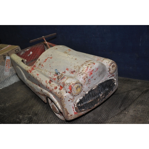 1057 - A 1950'S CHILDS TIN PLATE PEDAL CAR with distressed paint finish, total length 36in (Condition Repor... 