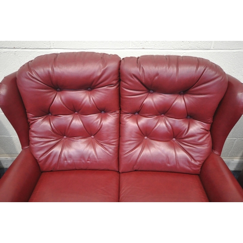 1319 - A CELEBRITY THREE PIECE BURGUNDY LOUNGE SUITE, comprising a two seater sofa, length 130cm x depth 90... 