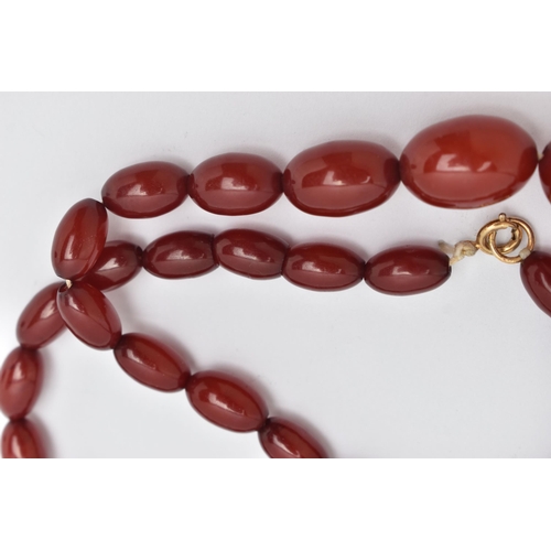 20 - A BAKELITE BEAD NECKLACE, comprising of thirty-five graduated oval shape beads measuring approximate... 